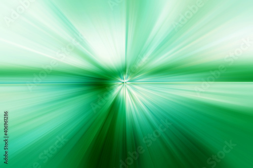 Abstract surface of a radial zoom blur of green and white tones on a green background. Abstract background with radial, radiating, converging lines.