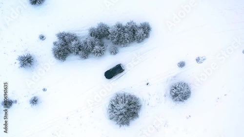 Offroad car trip through the Ukrainian Carpathians in winter. Christmas tree and snowy road. External expedition.Ice. Aerial view photo