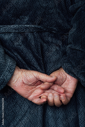 Older man's hands interlocked at the back