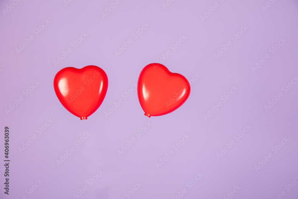 two hearts are lying next to each other on a purple background