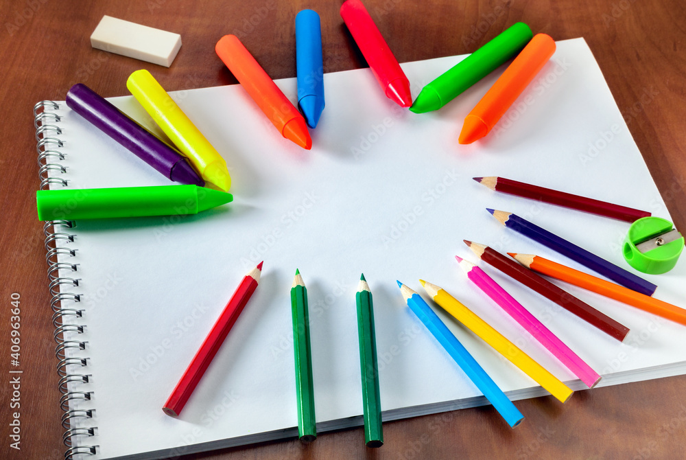 Colored pencils and a drawing pad. The concept of school children's creativity