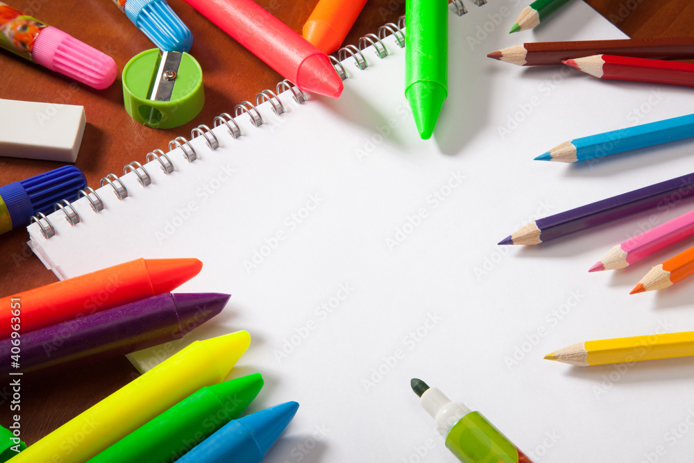 Colored pencils and a drawing pad. The concept of school children's creativity Colored pencils and a drawing pad. The concept of school children's creativity