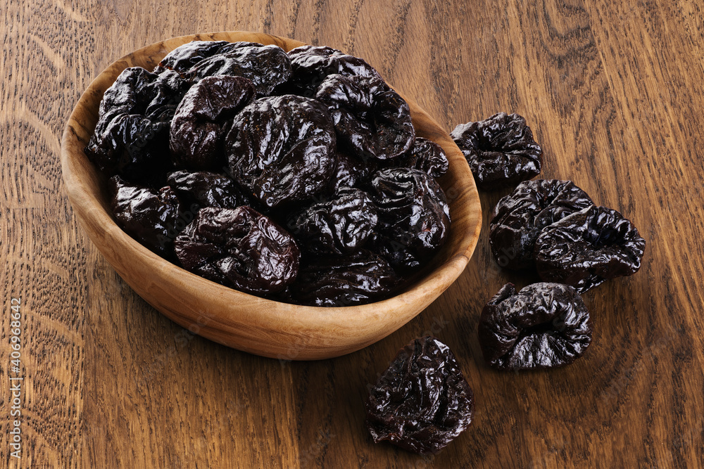 Dried plums on wooden background. Dried plums on wooden background.