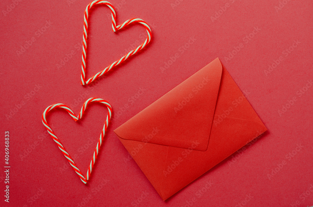 Festive red background. Hearts of sweet candies with envelope. Love. Valentine's Day. 14 of February. Flat lay, top view. Festive red background. Hearts of sweet candies with envelope. Love. Valentine's Day. 14 of February. Flat lay, top view.