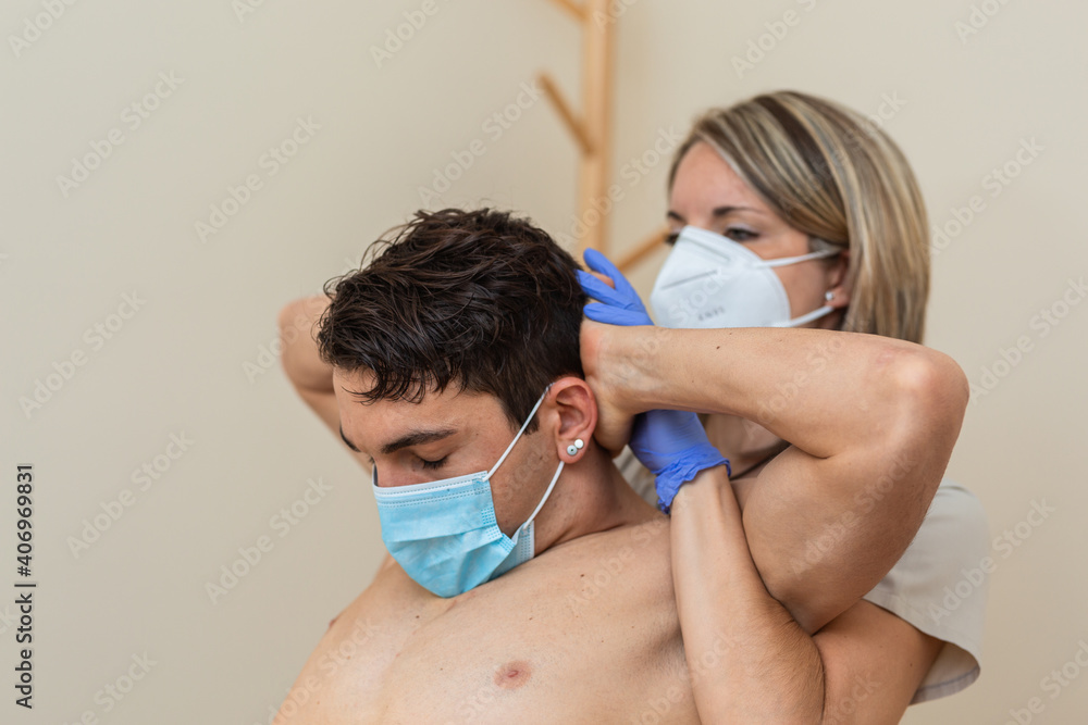woman physiotherapist with mask does massage. Cervical manipulation, thrust