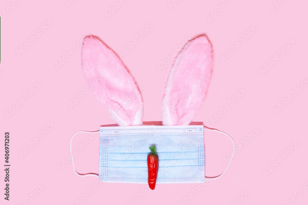 Easter bunny made from surgical face mask and decoration, rabbit and carrot. Easter holiday 2021 during Covid-19. coronavirus Quarantine Pandemic minimal concept Easter bunny made from surgical face mask and decoration, rabbit and carrot. Easter holiday 2021 during Covid-19. coronavirus Quarantine Pandemic minimal concept