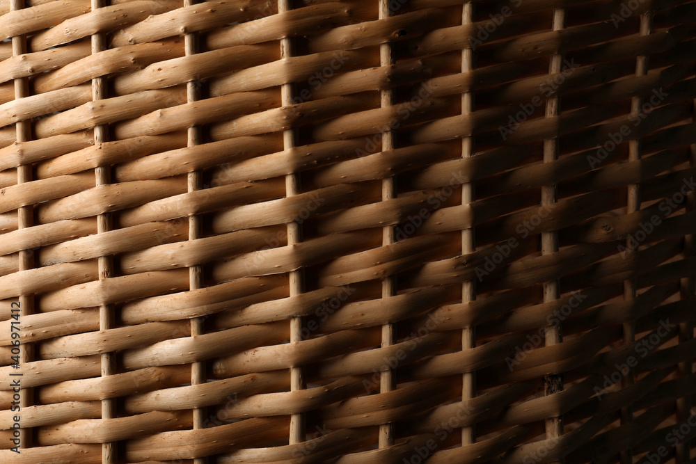 Handmade wicker basket made of natural material as background, closeup view Handmade wicker basket made of natural material as background, closeup view