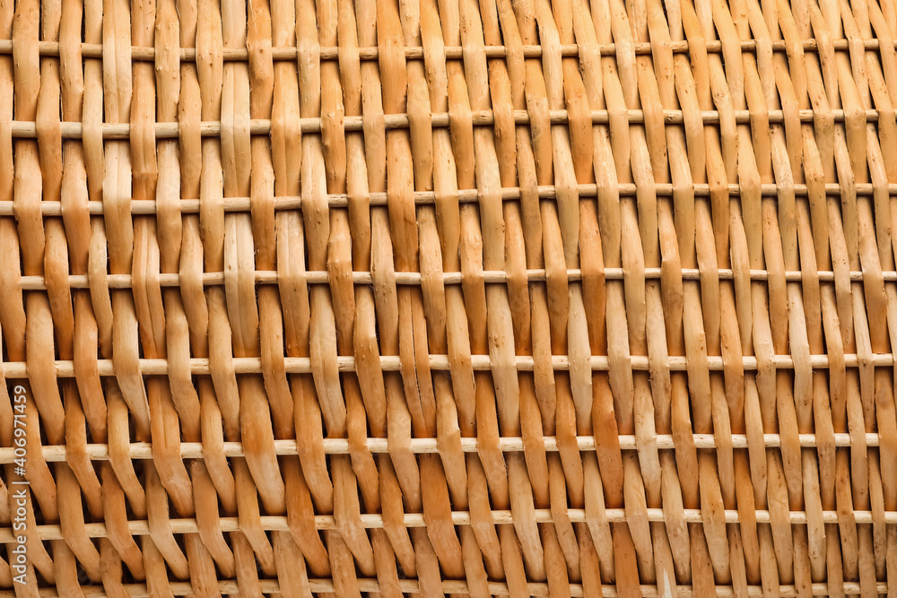 Handmade wicker basket made of natural material as background, closeup view Handmade wicker basket made of natural material as background, closeup view