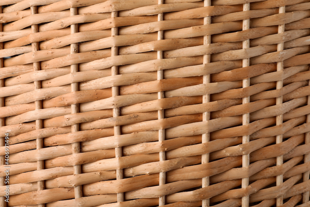 Handmade wicker basket made of natural material as background, closeup view Handmade wicker basket made of natural material as background, closeup view