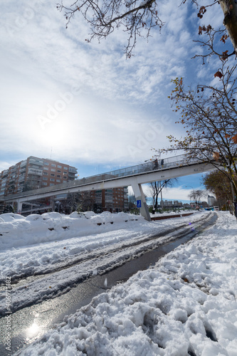 Angular view of an A2 highway bridge with snow, a sunny day, Madrid, Spain, Europe, January 10, 2021, vertical