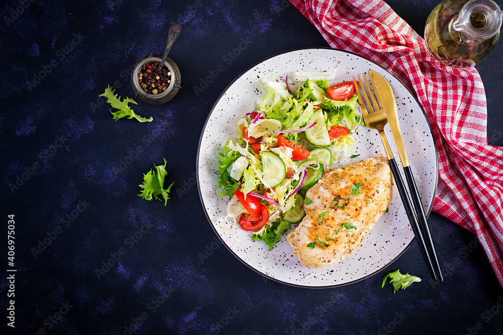 Ketogenic, keto food. Fried chicken fillet and fresh vegetable salad of tomatoes, cucumbers and lettuce. Chicken meat with salad. Healthy food. Top view, flat lay, copy space Ketogenic, keto food. Fried chicken fillet and fresh vegetable salad of tomatoes, cucumbers and lettuce. Chicken meat with salad. Healthy food. Top view, flat lay, copy space