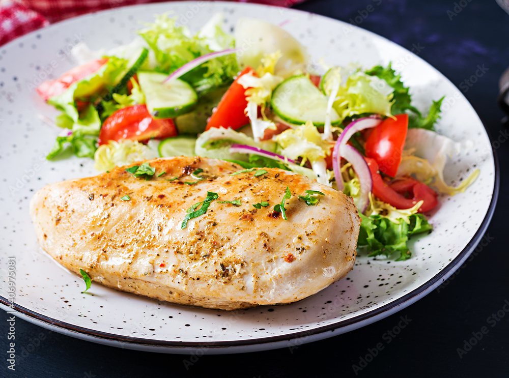 Ketogenic, keto food. Fried chicken fillet and fresh vegetable salad of tomatoes, cucumbers and lettuce. Chicken meat with salad. Healthy food. Ketogenic, keto food. Fried chicken fillet and fresh vegetable salad of tomatoes, cucumbers and lettuce. Chicken meat with salad. Healthy food.