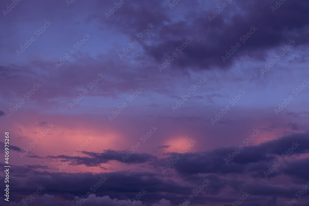 Fototapeta premium Sunrise, sunset pink violet blue sky with dark storm clouds background texture 