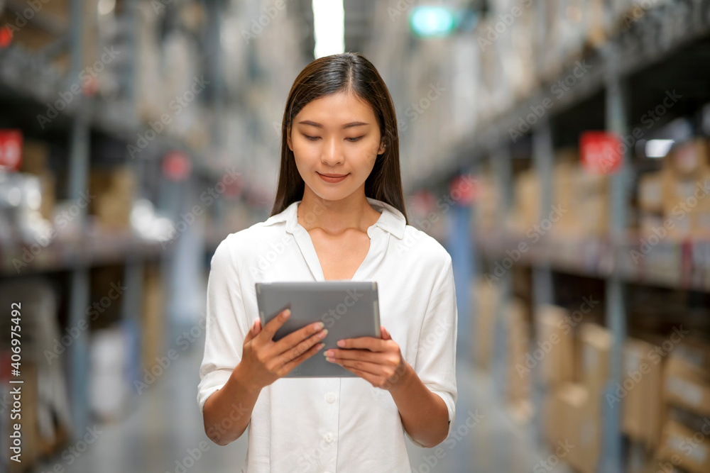 Young Asian female use tablet check spec of goods in department store. Young Asian female use tablet check spec of goods in department store.