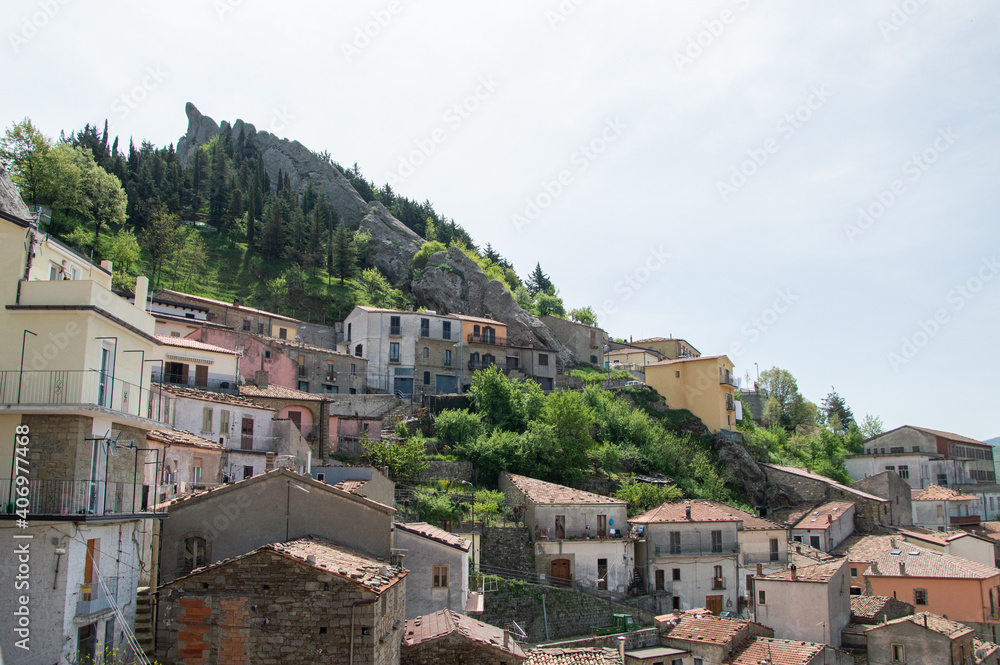 view of the small village of Pietrapertosa in Basilicata, Italy with background of mountains and forest