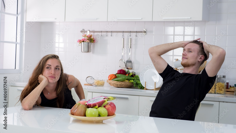 Portrait of couple using laptop in the kitchen