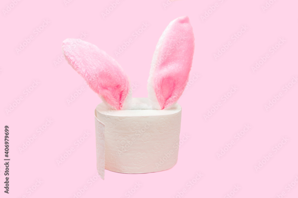 pink Rabbit ears peek from toilet paper on pink background. Bunny ears out of toilet paper roll. Easter holiday 2021 during Covid-19. coronavirus Quarantine Pandemic concept pink Rabbit ears peek from toilet paper on pink background. Bunny ears out of toilet paper roll. Easter holiday 2021 during Covid-19. coronavirus Quarantine Pandemic concept