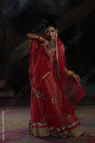 Portrait of beautiful indian girl with kundan jewelry set. Traditional India costume lehenga choli or sari.