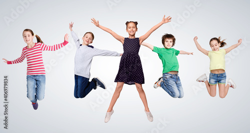 Cheerful Boys And Girls Jumping On Gray Studio Background, Collage