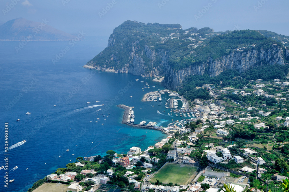 Amazing perspective from Anacapri, Villa San Michelle, towards the exclusive harbor Marina Grande where many celebrities anchor their yachts and surrounding residences on the island of Capri, Italy