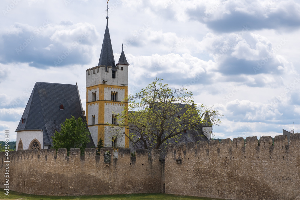 View of the old city wall of Ingelheim / Germany with the tower of the Bergkirche behind it