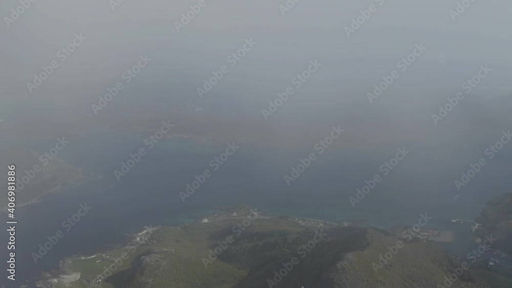 Incredible top view of cloudy mountain ocean in Lofoten Islands,NORWAY Incredible top view of cloudy mountain ocean in Lofoten Islands,NORWAY