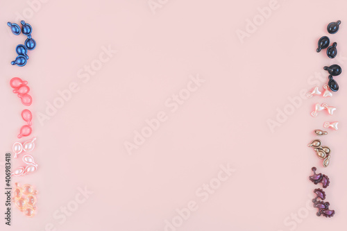 various types of collagen and peptides capsules on pink background. cosmetic product in capsules for skin care and beauty. copy space for text. © Yulia Panova