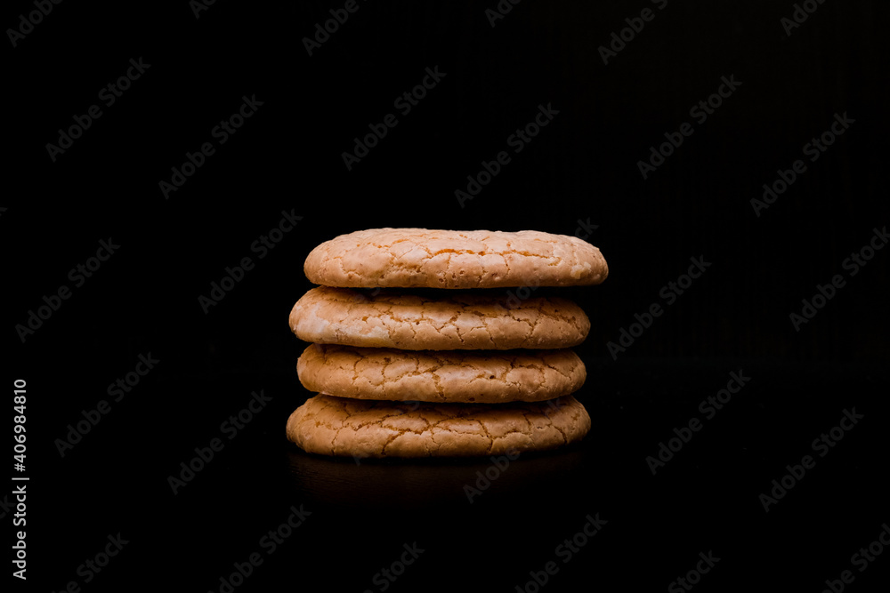 Almond cookies stacked on dark background Almond cookies stacked on dark background