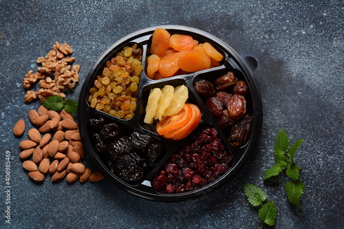 Mix of dried and sun-dried fruits, in a wooden trays . View from above. Symbols of the Jewish holiday of Tu BiShvat