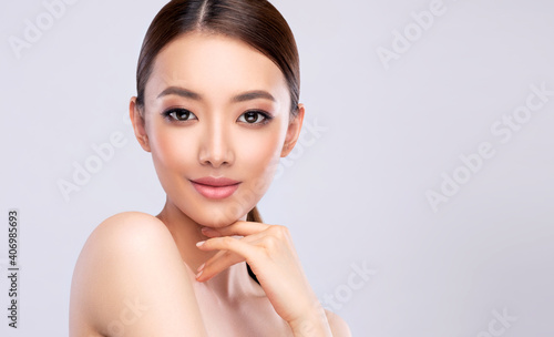 Beautiful young asian woman with Clean Fresh Skin on face . Chinese girl Facial treatment . Cosmetology , beauty and spa .
