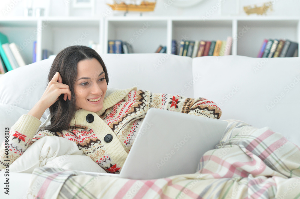 young beautiful woman with laptop  on sofa