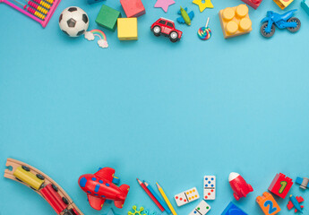 Frame of wooden and plastic kids toys on blue background