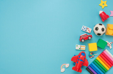 Frame of wooden and plastic kids toys on blue background