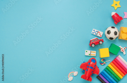Frame of wooden and plastic kids toys on blue background