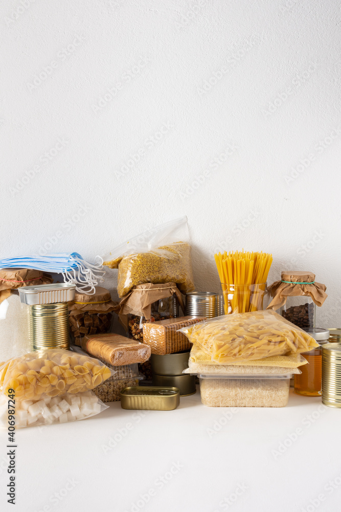 Home food supplies, necessary food for the period of quarantine and isolation, the concept of stay at home, canned food and cereals, various pasta and flour, honey and coffee, protective masks