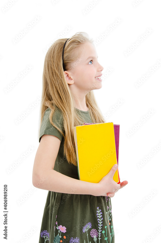 Portrait of beautiful young girl holding books looking on copy space. Isolated on white background
Portrait of beautiful young girl holding books looking on copy space. Isolated on white background