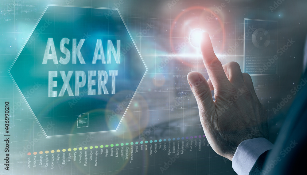 A businessman controlling a futuristic display with a Ask An Expert business concept on it.