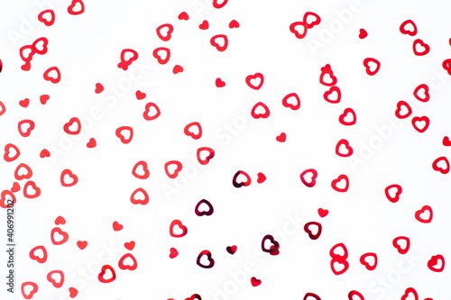 Valentine s Day background February 14th. Red hearts confetti on white background. Valentines day creative concept. Flat lay  top view  copy space.