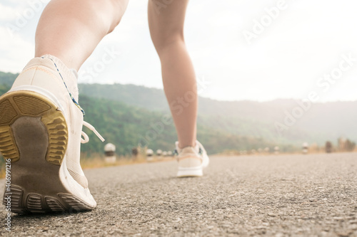 woman legs,running on empty road