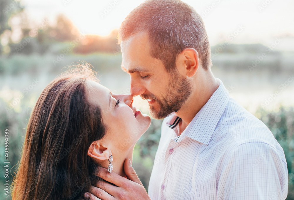 faces of a young girl and a guy in a kiss and hug faces of a young girl and a guy in a kiss and hug
