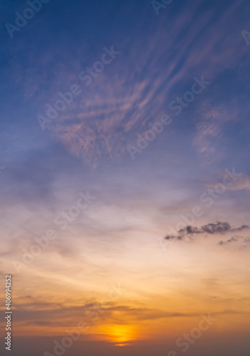 Sunset sky in the evening on twilight with orange and purple sunlight sky nature background,Dusk sky vertical. 