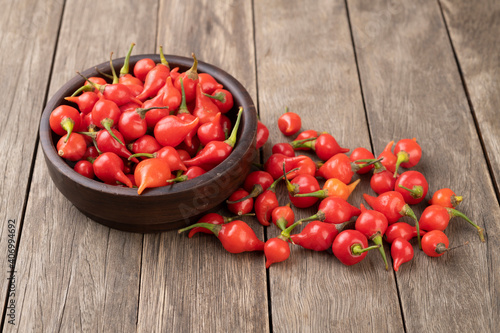 Fotografia Red pepper pout on a bowl over wooden table