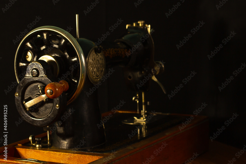 Fototapeta premium gray sewing machine on a black background