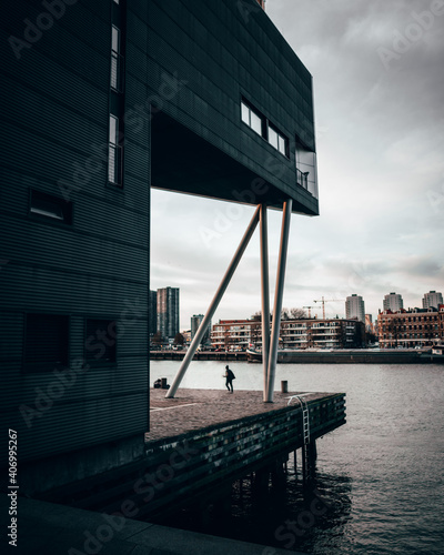 A person in front of an architectural building