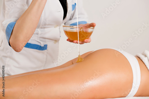 anti-cellulite massage with honey, close-up photo