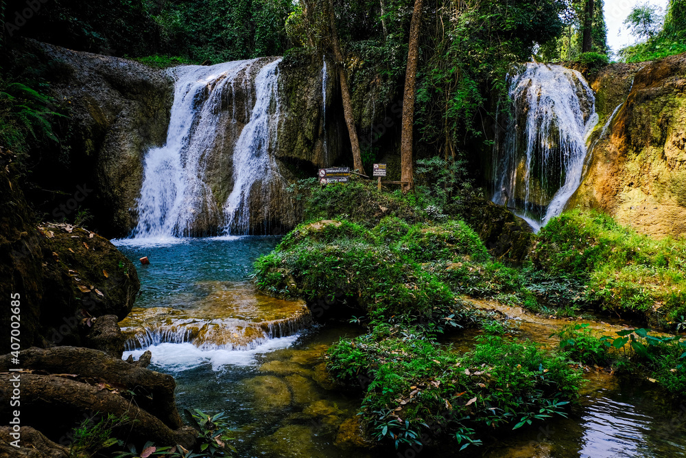 Fototapeta premium Paradise waterfall in deep forest turquoise water