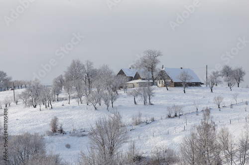 Winter frosty landscape of the beautiful Transylvanian village, Bran, with fresh snow, at the foot of the Carpathian Mountains © alexionutcoman