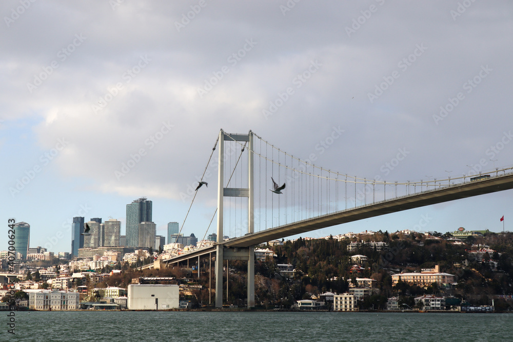 Naklejka premium The Bosphorus Bridge, thus connecting Europe and Asia (alongside Fatih Sultan Mehmet Bridge and Yavuz Sultan Selim Bridge). The bridge extends between Ortaköy (in Europe) and Beylerbeyi (in Asia).