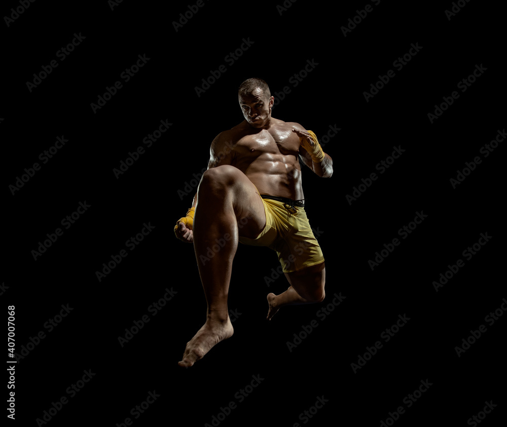 Thai boxer on boxing ring, jump and kicking