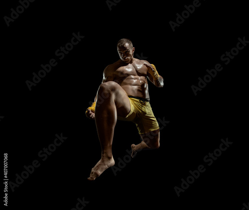 Thai boxer on boxing ring  jump and kicking